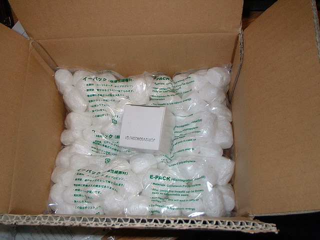 Small box surrounded by packing peanuts in a larger box